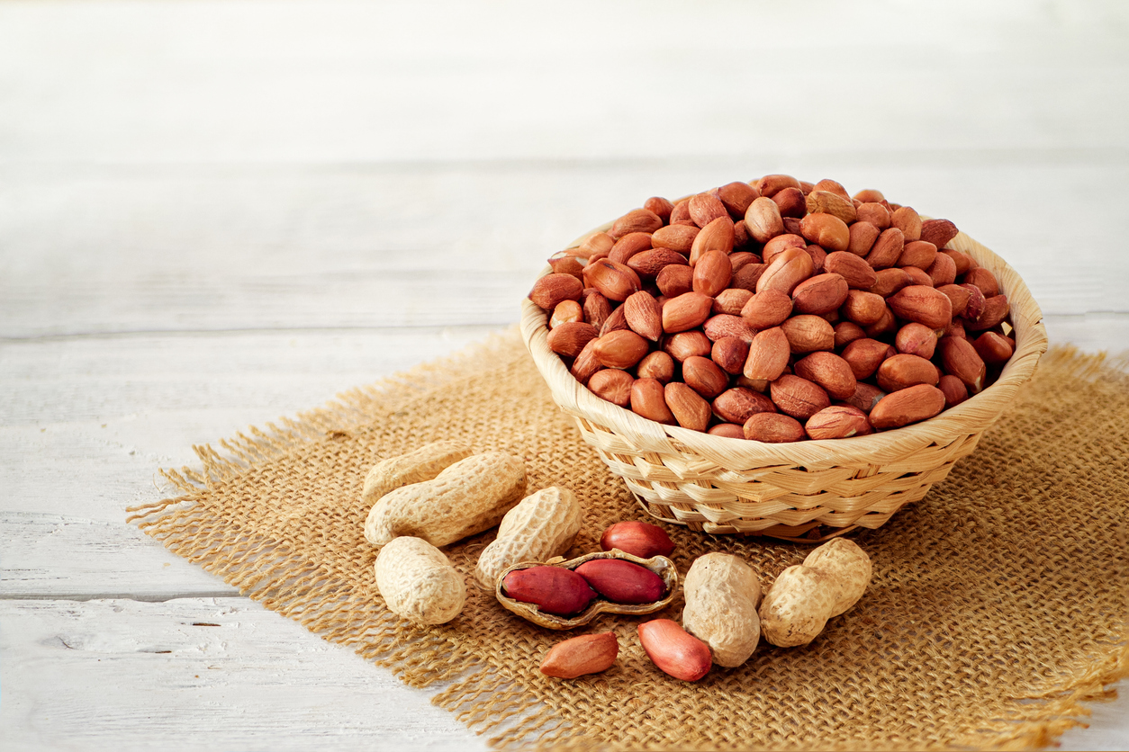 peanuts both shelled and in shells in a wicker basket